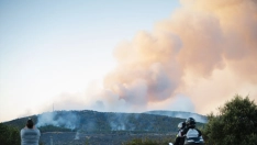 Varias personas observan el incendio de Lozoyuela. Mateo Lanzuela / Europa Press