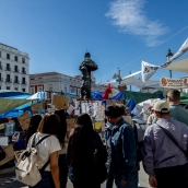 Varias personas observan los mensajes, en la Puerta del Sol. Ricardo Rubio / Europa Press