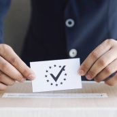 man putting ballot box